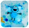 COOKIE MONSTER GLO PALS - POSTAĆ DO KĄPIELI zestaw z dwiema kostkami sensorycznymi świecącymi w wodzie ULICA SEZAMKOWA